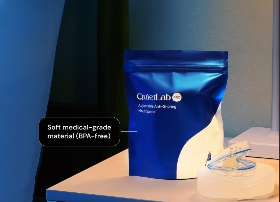 QuietLab Pro mouthpiece and case beside its blue packaging